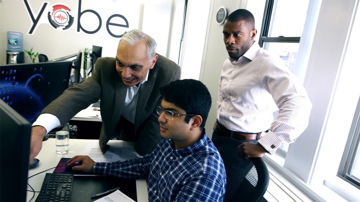 Dr. Nawab and Ken Sutton consult with a software developer at Yobe headquarters in Boston.