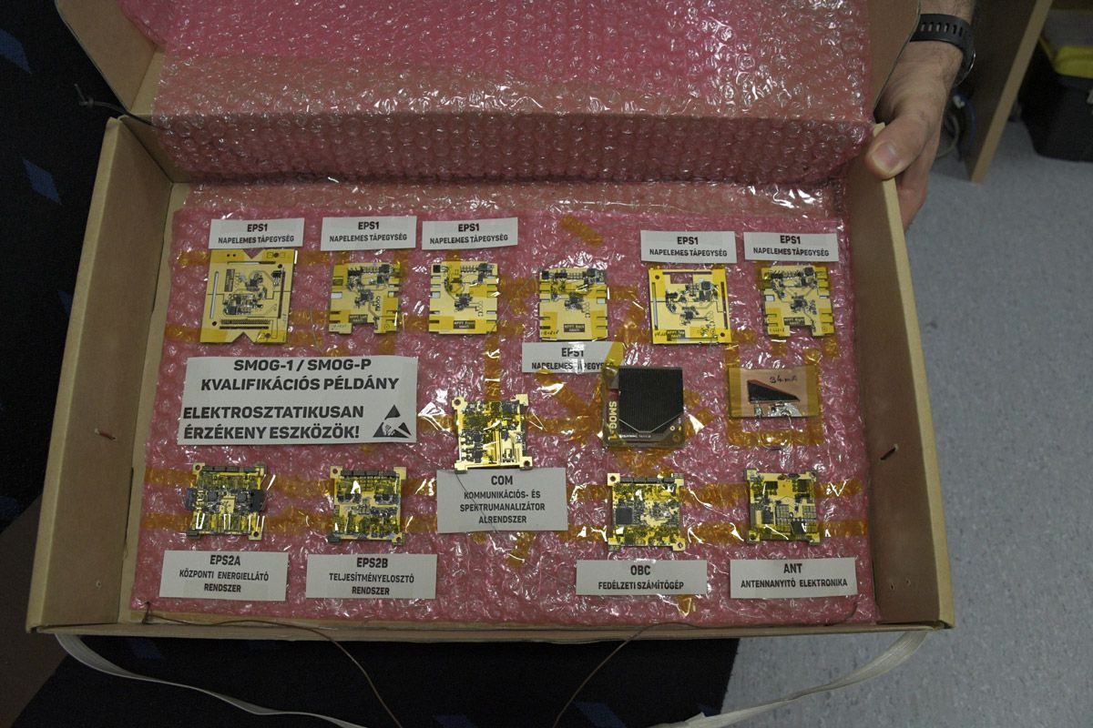 An open, large shoebox displaying the printed circuit boards.