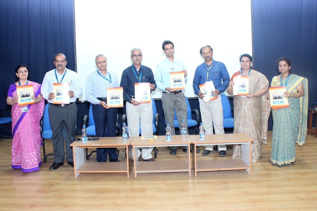 Several members of the R V C E faculty holding lab manuals.